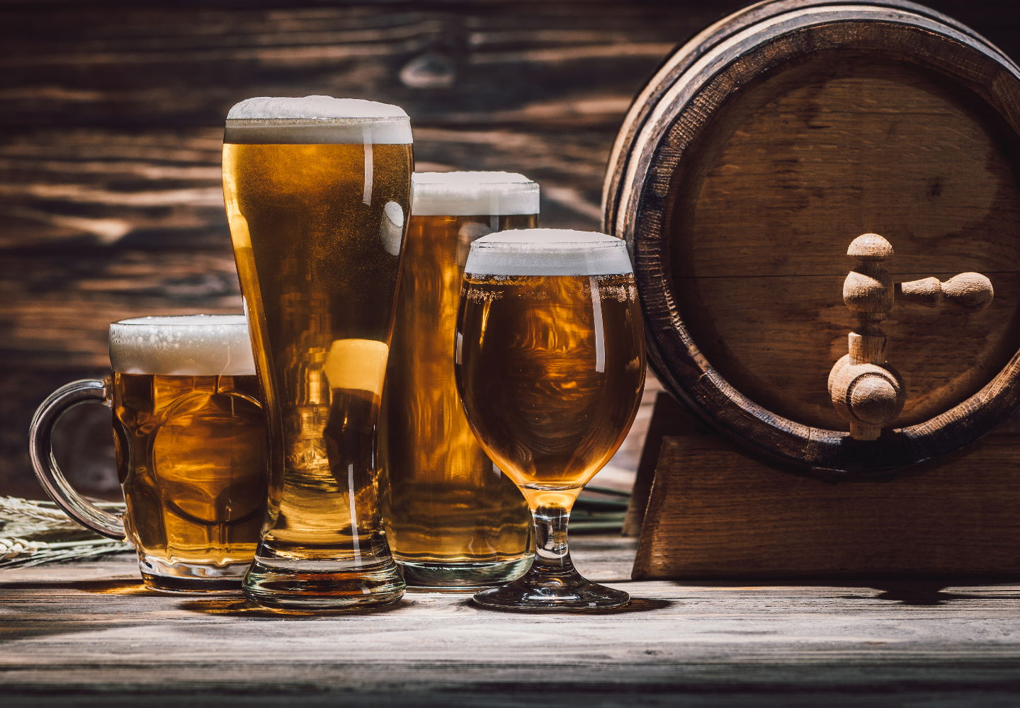 fresh beer in glasses and beer barrel on wooden table, oktoberfest concept